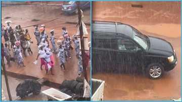 Pastor and wife cruise in 4x4 while church members march in heavy rain to announce the gospel