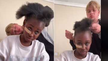 TikTok video of teenage girl's boyfriend styling her natural 4c hair gets rated by Ghanaian viewers: "I'm jealous"