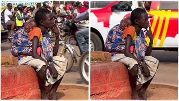 "Critical thinking": Young girl with sleeping baby on her back sits by roadside, video emerges on TikTok
