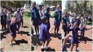 Little schoolgirl in long sleeves gives killer waist moves as she dances in front of students in cute video