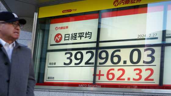 Asian markets mostly lower as traders await fresh data