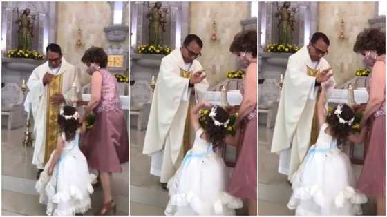 Funny moment little girl gives catholic priest high-five during prayer session