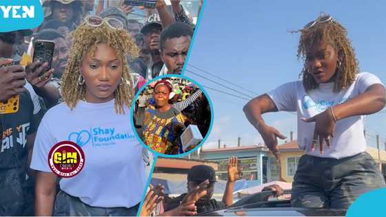 Wendy Shay shares phones at Kasoa, market woman Prays for her to become president