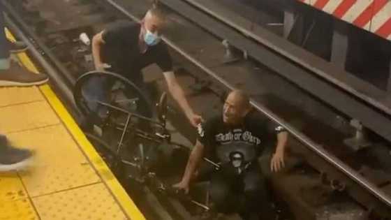Heroic bystander saves life of disabled man who fell on train tracks with wheelchair, video pops up