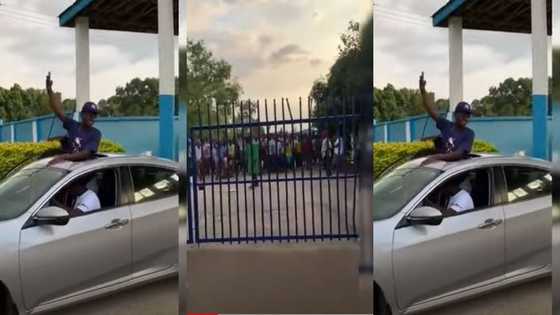 Yaw Tog goes to school in an 'open top' car; colleagues flow him 'fans'