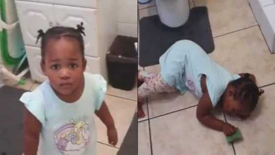 Drama queen: Baby plays dead after being caught red-handed for writing on the wall