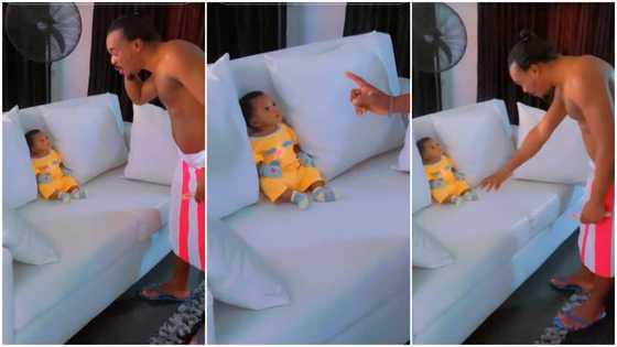 Dad warns newborn daughter, baby looks at him with serious face, listens carefully