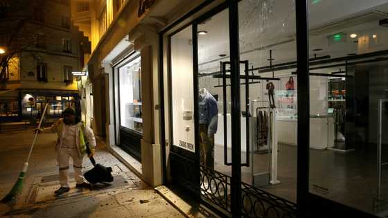 French climate activists target store lights in Paris night raids