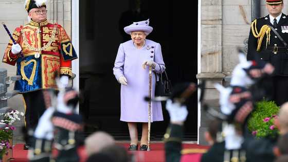 Queen's coffin heads to Scottish palace, historic church
