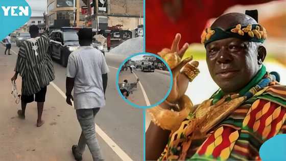 Man in fugu throws himself on the floor as Otumfuo rides through Adum in his 90-year-old car