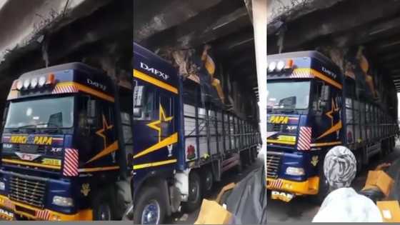 Video pops up as overloaded truck gets stuck under Achimota overheard; Ghanaians 'bore'