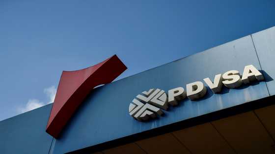 A Swiss and an Argentine were charged in Miami Tuesday with helping launder part of $1.2 billion taken from Venezuelan state oil firm PDVSA in a long-running corruption and bribery investigation.