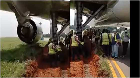 Plane gets stuck in mud while preparing to take off, video shows officials using shovel to clear it