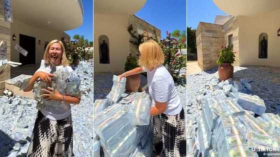 Wealthy lady fills her compound with bundles of cash, plays with money in video