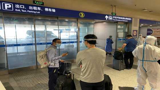 China halves quarantine time for overseas travellers