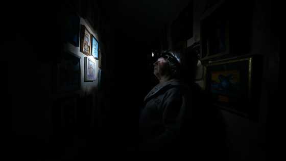 Defiance by candlelight as Kyiv adapts to blackouts