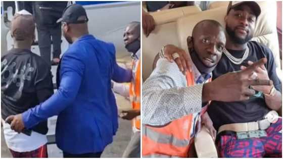 Davido invites airport staff into his jet, takes photo with him moments after bodyguard pushed him away