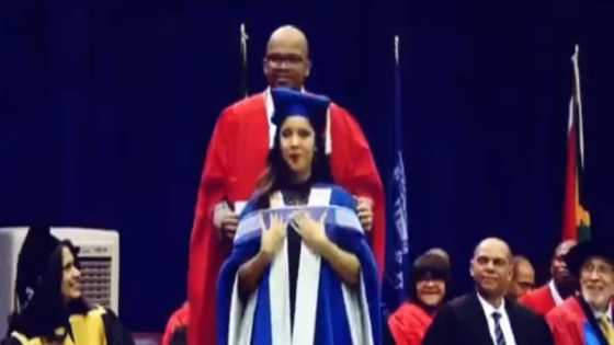 Sweet moment as senior lecturer with PhD crowns his wife with PhD sash at her graduation