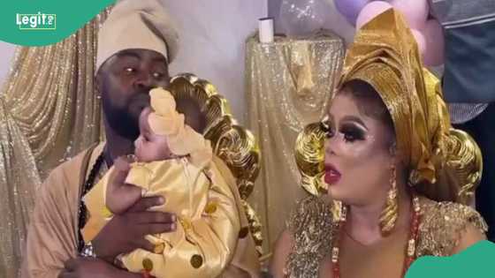 Lady resembles Bob Risky as she rocks heavy makeup to her twin's christening: "Na d man ex do am"