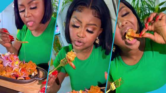 Nana Ama ditches the fork, uses her hands to enjoy a large meat and seafood platter in video