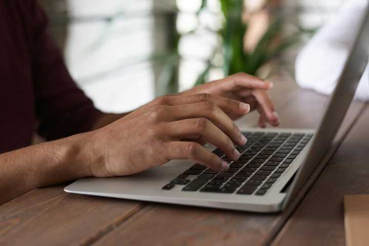 A person typing on a laptop